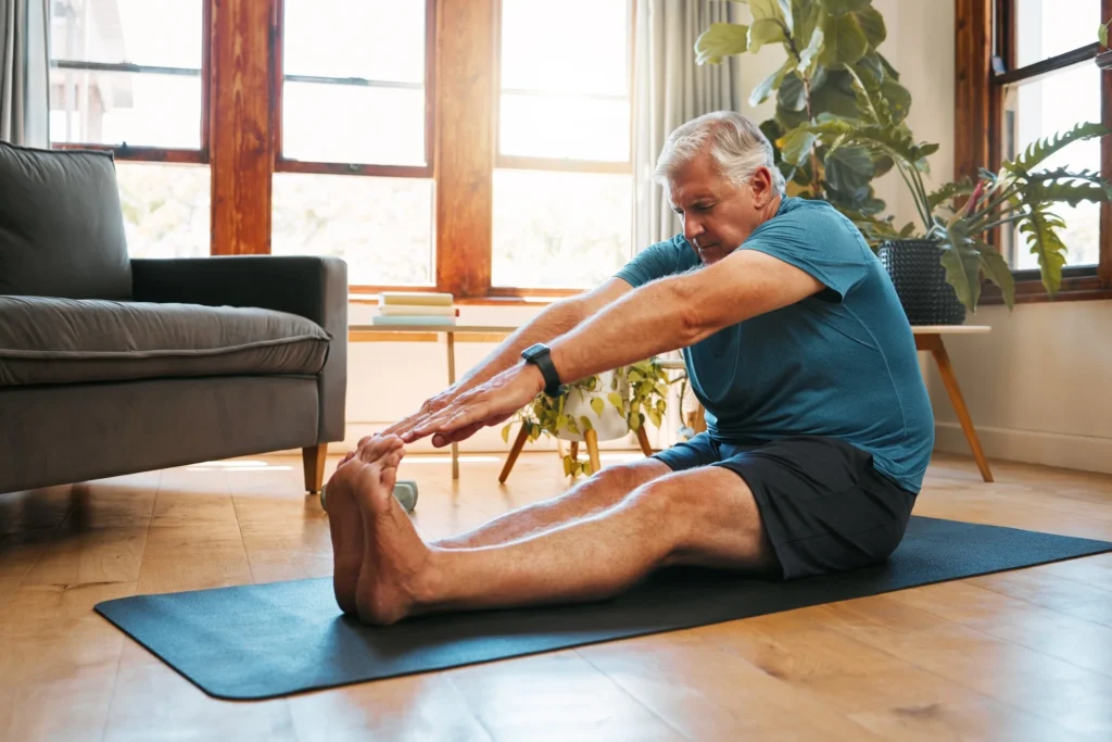 Older adult exercising at home to build a weekly fitness routine
