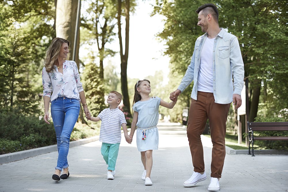 Family walking together in a park on a sunny day